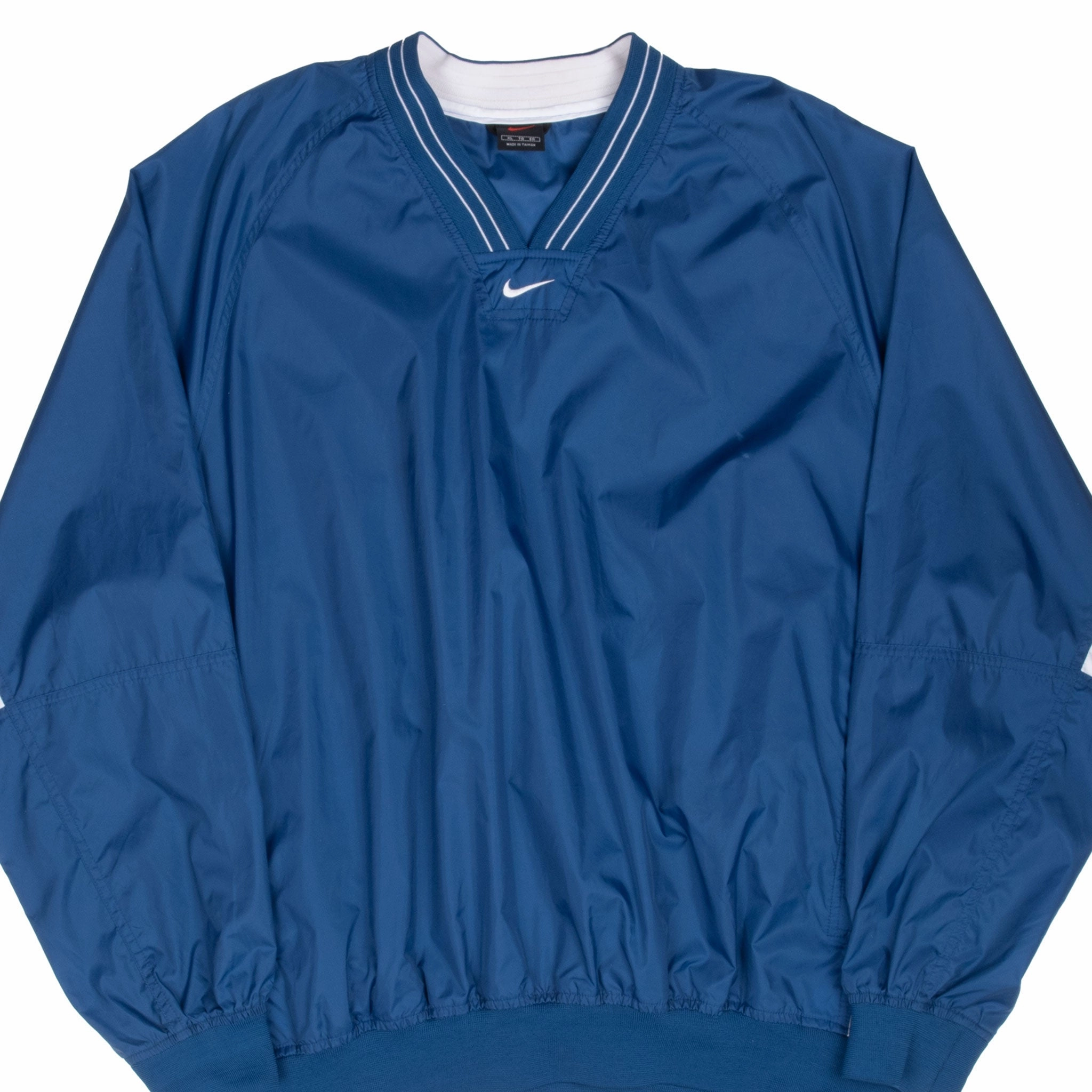 Hear VINTAGE NIKE CENTER SWOOSH BLUE WINDBREAKER PULLOVER JACKET 1990S XL